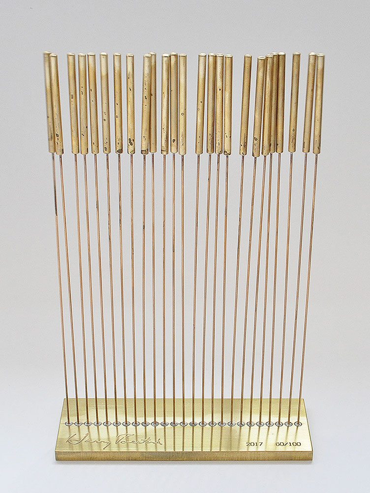 Row of Harry Bertoia's small sonambients instruments in gold metal 