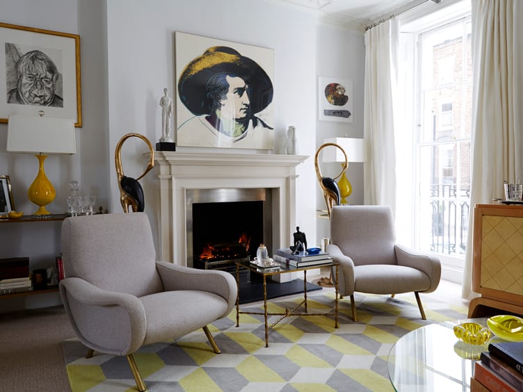 Living room with matching gray armchairs and yellow and gray geometric rug