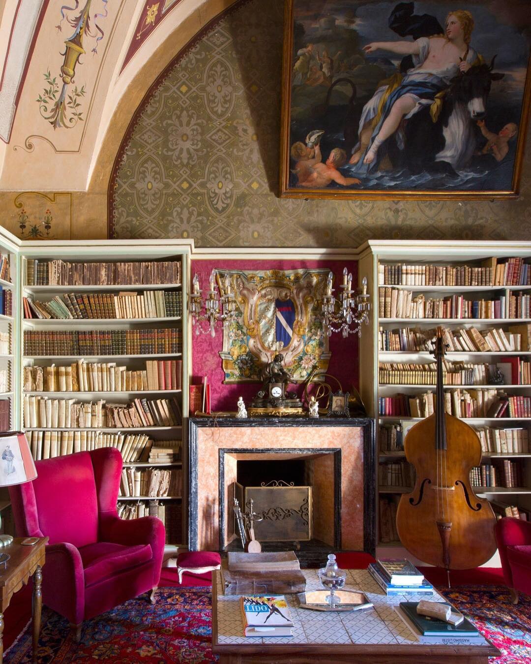 oberto gili home library bookshelves pink velvet reading chair bass fireplace renaissance art