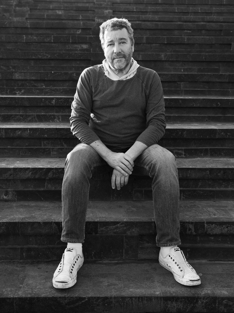 A portrait of Philippe Starck, inventor of the Ghost Chair, an iconic chair design of the 21st century 